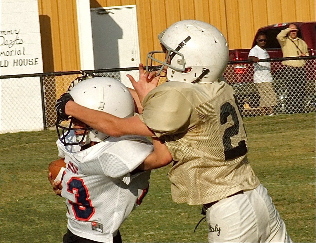 Image: Levi McBride(28) forces a Mustang runner out-of-bounds the hard way.