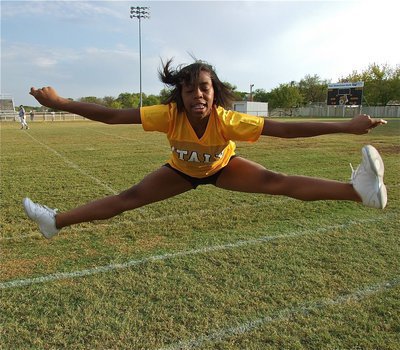 Image: IJH cheerleader Quintera Washington leaps high to help raise the spirit.