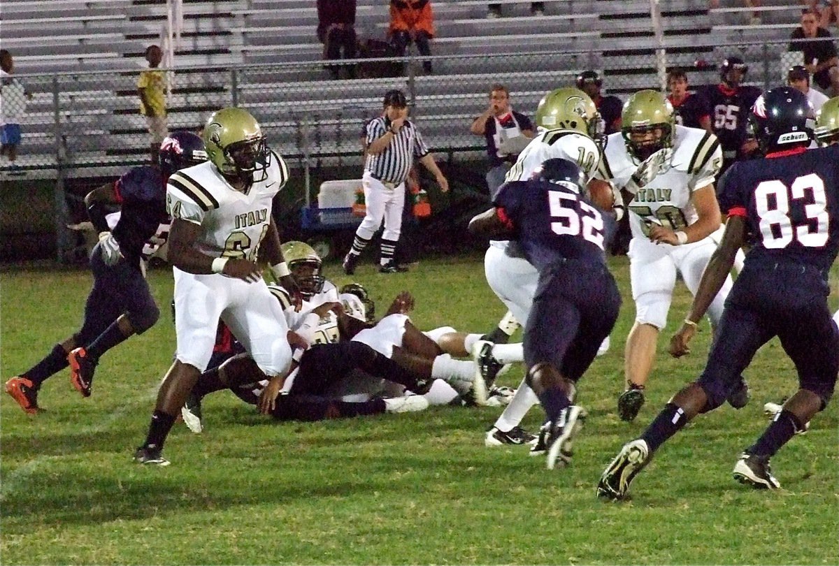 Image: Gladiators Adrian Reed(64), Larry Mayberry(77) and Zain Byers(50) open a running lane for tailback Ryheem Walker(10).