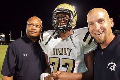 Image: Gladiator assistant coach Larry Mayberry, Sr., poses with his son, Larry Mayberry, Jr.(77) and what appears to be a cardboard cutout of Italy’s defensive coordinator, Jeff Richters as the trio enjoy their 46-0 win over the Mustangs.