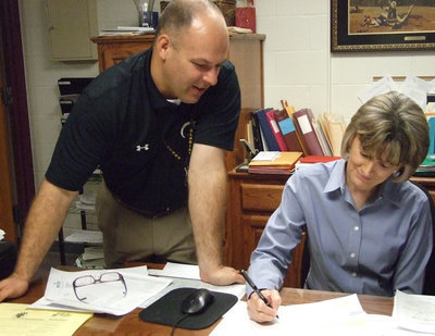 Image: Mr. Joffre and high school secretary, Angela Muirhead, talk over some details about the high school.