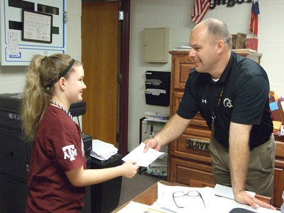 Image: Mr. Joffre puts the students in the focus.  Tara Wallis is giving the new principal a reason to smile.