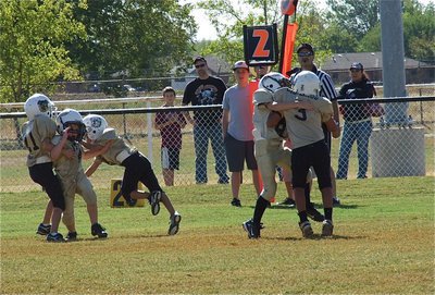 Image: Bryce DeBorde(4) fights thru a double team while teammate Preston Rasco(9) tackles the Bulldog quarterback for a loss.