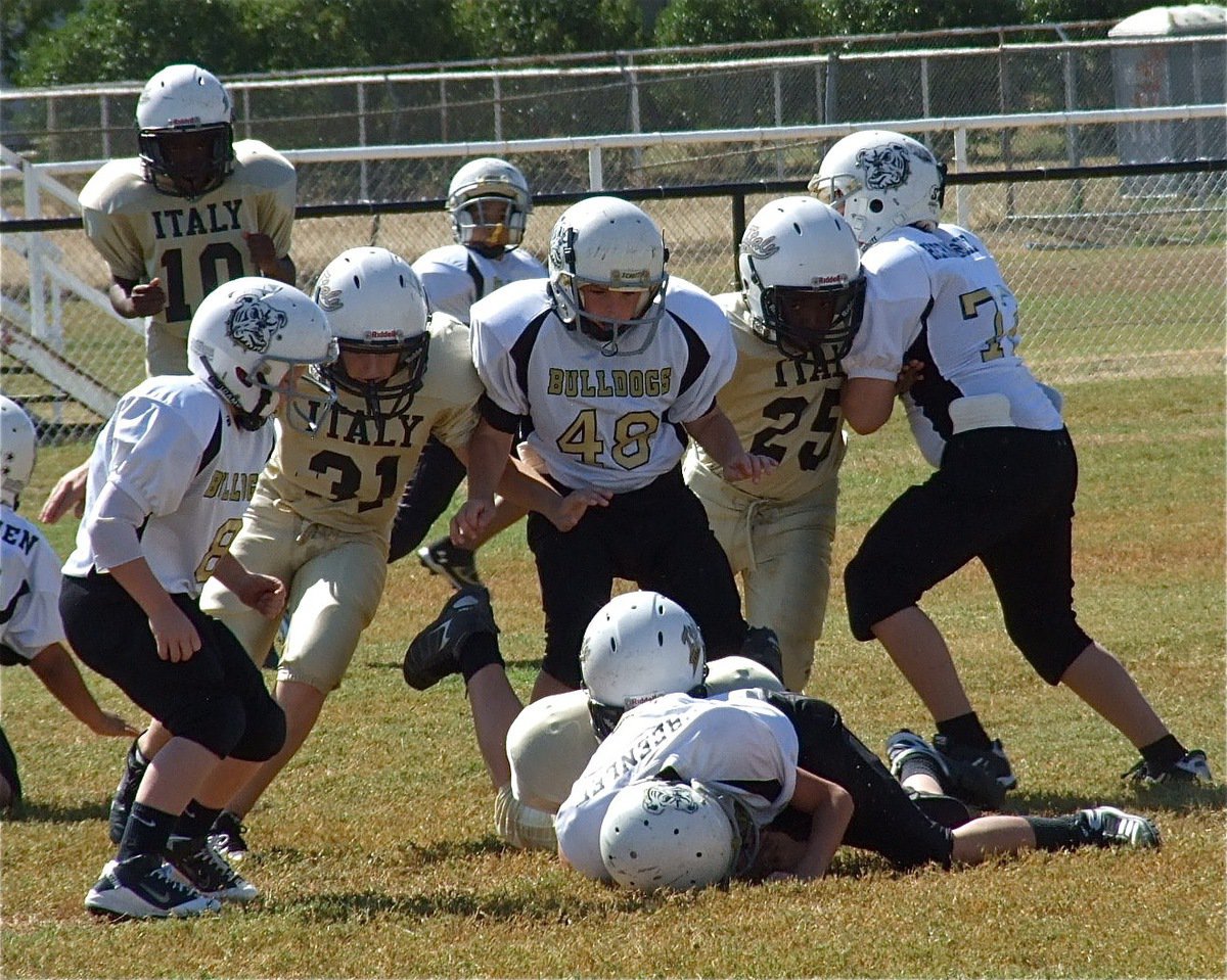 Image: Fumble! Clay Riddle(31) and Adam Powell(25) track the play while teammate Isaac Salcido(80) fights for the loose ball and recovers it for the IYAA A-team Gladiators.