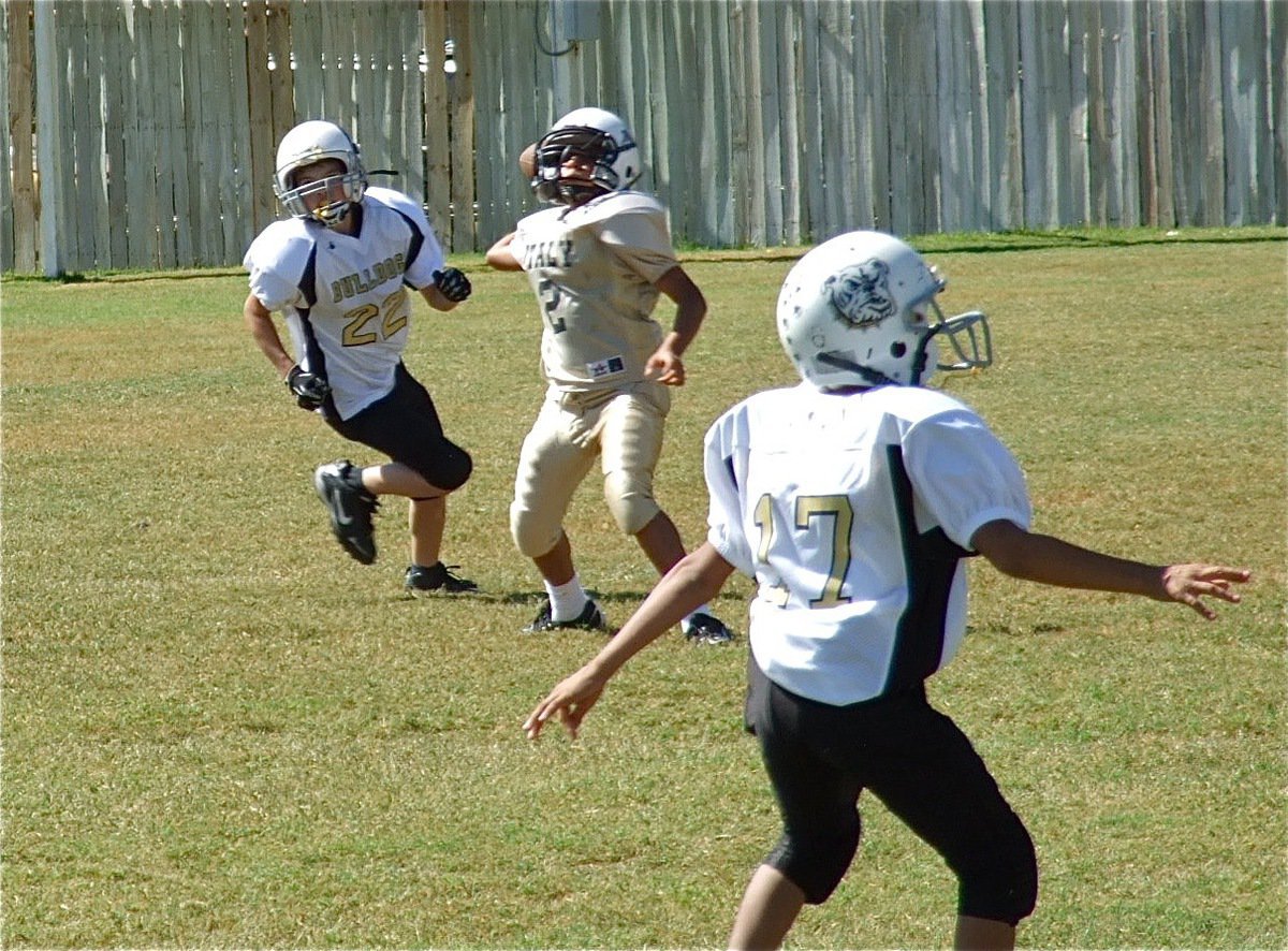 Image: A-team quarterback Tylan Wallace(2) pulls up and throws the deep ball to Kendrick Norwood who reaches high in the air for a completion.