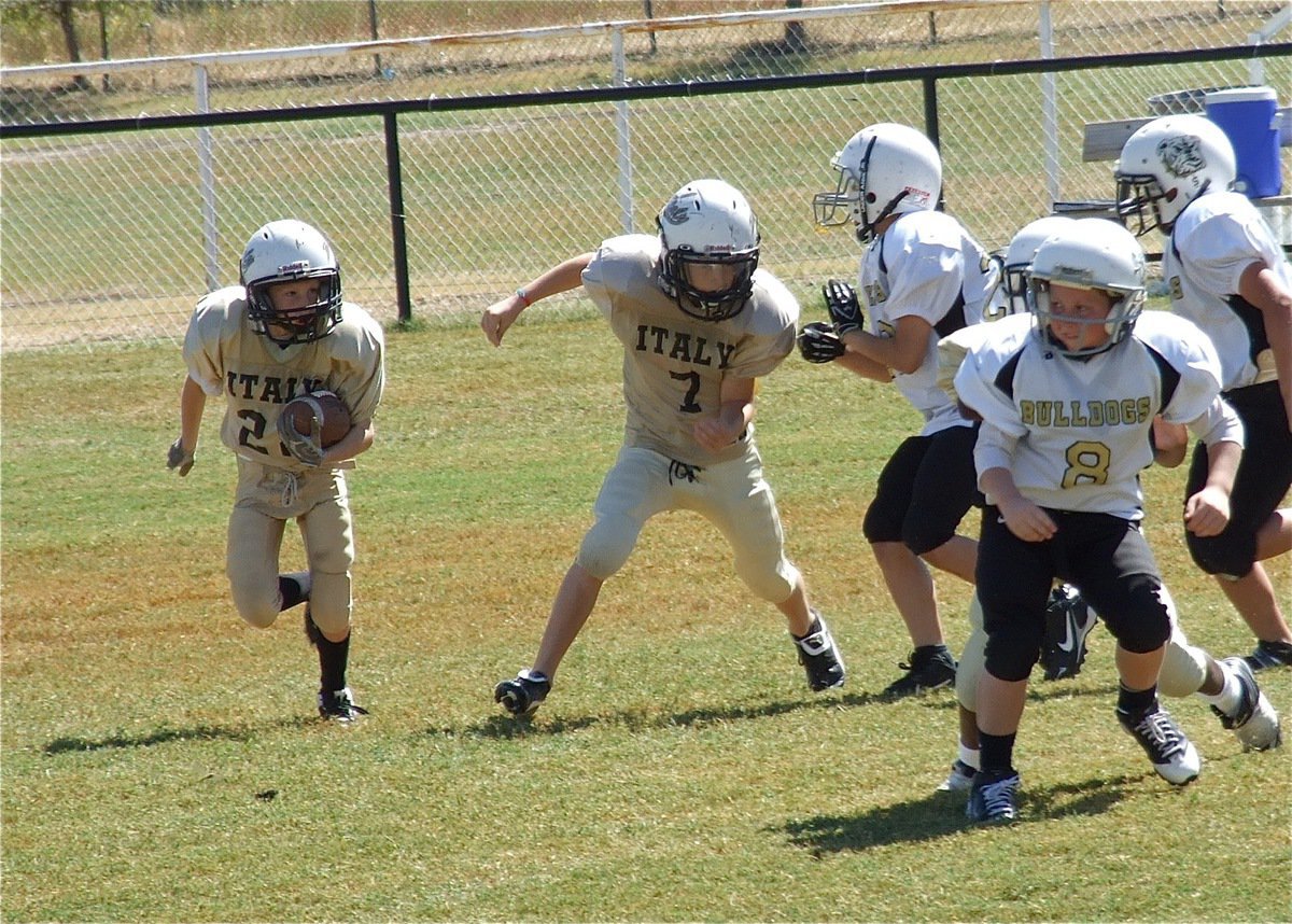 Image: Garrett Cash(28) is on the loose and gets a block from teammate Ryder Itson(7) during the A-team game.