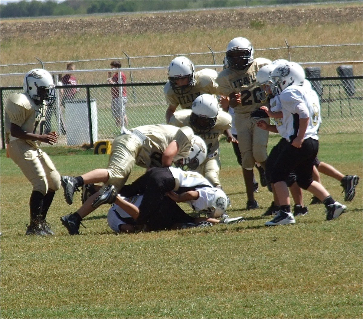 Image: Isaac Salcido(80) delivers the final knockout as the IYAA A-team defeats Palmer 32-0.