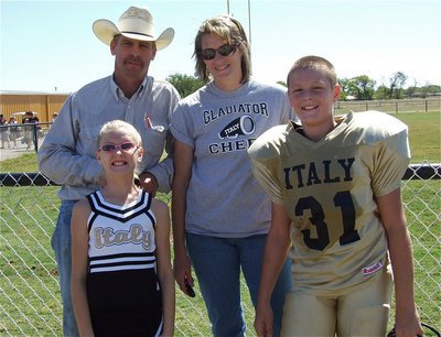 Image: Curtis and Michele Riddle are proud of their daughter and IYAA B-team cheerleader Courtney Riddle and their son, A-team football player Clay Riddle.