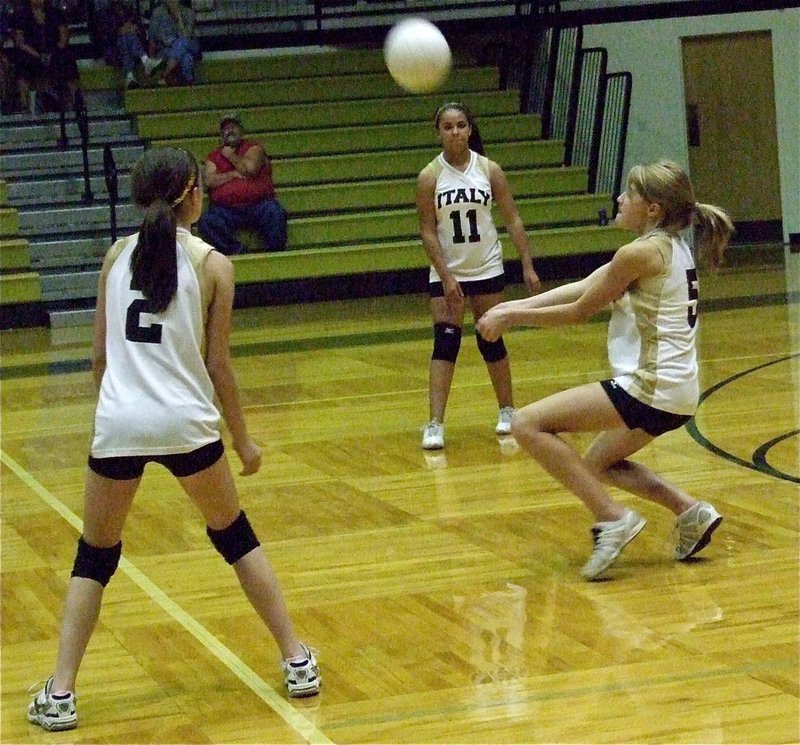 Image: Halee Turner(5) attacks the ball with Cassidy Childers(2) and Ashlyn Jacinto(11) on her flanks.