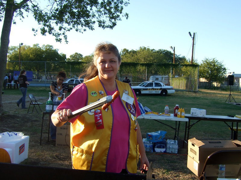 Image: Italy Lions Club member cooking up the “dogs”.