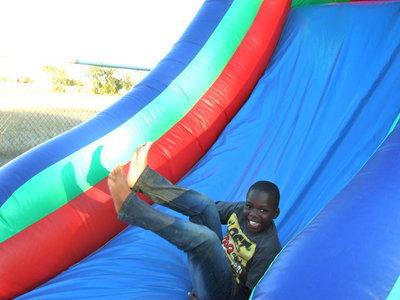 Image: Having lots of fun on the bounce house slide.