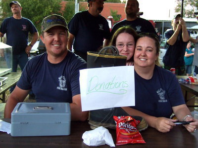 Image: Mark Jackson, Cheyene and Wendy Frank were busy getting donations for the Milford Fire Department.