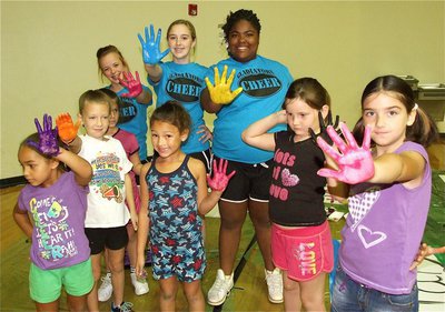 Image: IHS cheerleaders Felicia Litlle, Kelsey Nelson and Sa’Kendra Norwood show their painted hands along with their IYAA understudies, Taeja Anderson, Karley Sigler, Taylor Souder, Cadence Ellis, Kammie Magness and Farrah Eglich.