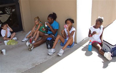 Image: IHS cheerleader Jameka Copeland takes a lunchbreak with the campers.