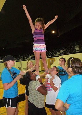 Image: Lajada Jackson, Annie Perry and Carlee Wafer hoist Emma Martinez high into the air, just like the IHS Cheerleaders do! Madison Washington, Bailey DeBorde and Destani Anderson supervise for safety.