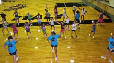 Image: Madison Washington, Destani Anderson and Beverly Barnhart teach the campers a dance routine.