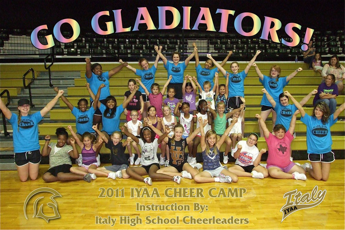 Image: IYAA cheer campers, Clover Stiles and the IHS varsity cheerleading coaches raise their hands in triumph. 