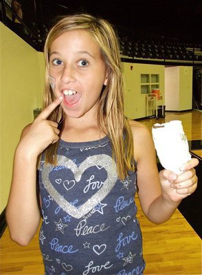 Image: IYAA Cheerleader Hannah Haight learned how to make a noise maker from a plastic bottle during the camp, but Hannah’s not convinced she needs any assistance in making some noise.