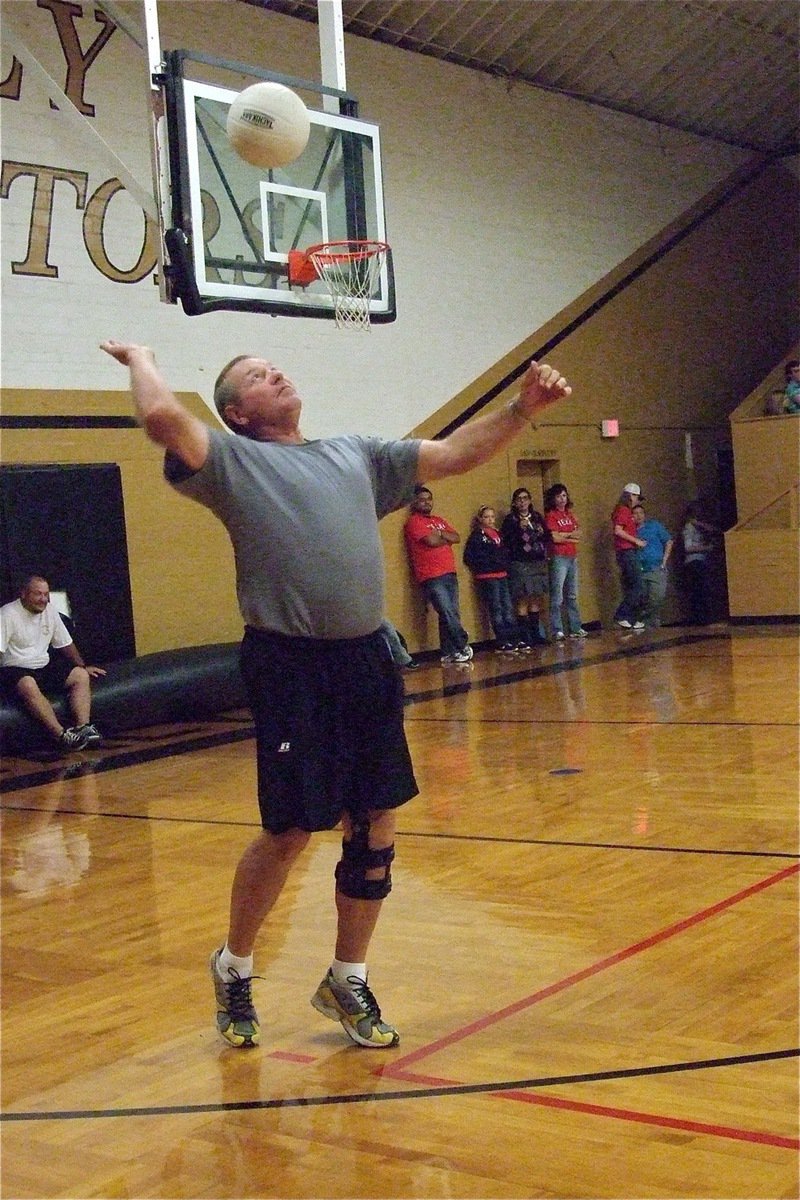 Image: Coach Parks shows the form on his serve.