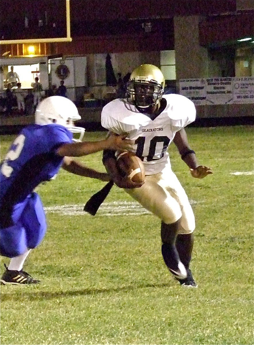 Image: The Lions struggled to get a paw on JV Gladiator quarterback Marvin Cox(10) who ran 73-yards for the game’s first touchdown.