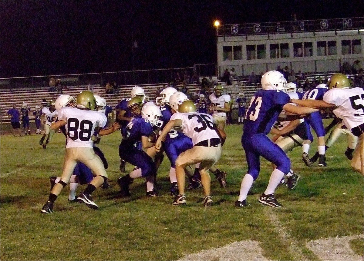 Image: John Escamilla contains the edge while teammate Cody Boyd(36) zeroes in a Lion runner.