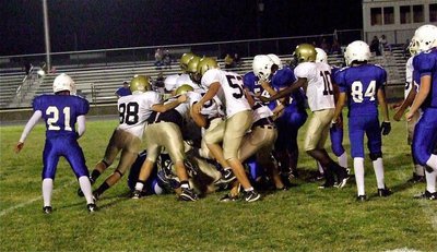 Image: Lion pile! Plenty of JV Gladiators get involved on this defensive play.