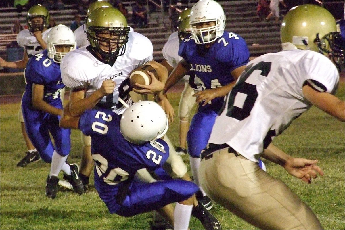 Image: Justin Wood(48) rams his way over the Lion defenders.