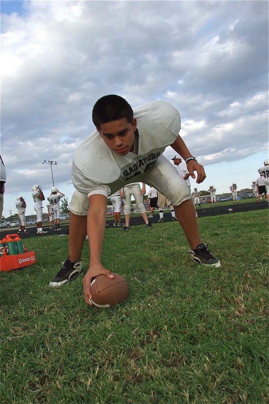 Image: David De La Hoya(70) practices shotgun snaps before the Italy Jr. High Gladiator game against the Blooming Grove Lions.