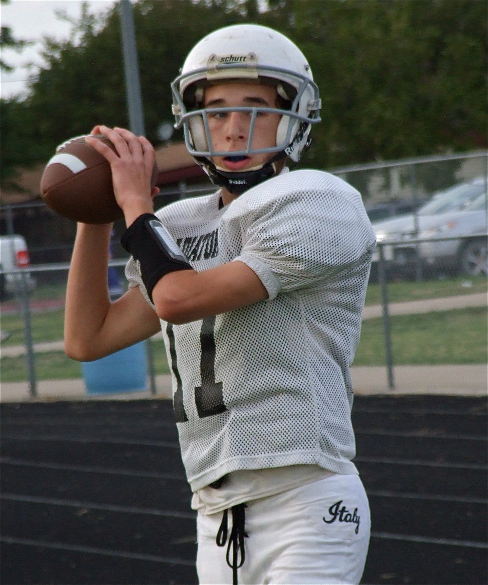 Image: Quarterback Ryan Connor gets loose on the sideline before the kickoff.