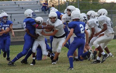 Image: Joe Celis(6) follows a block applied by Chasston King(20) and then powers thru the hole.