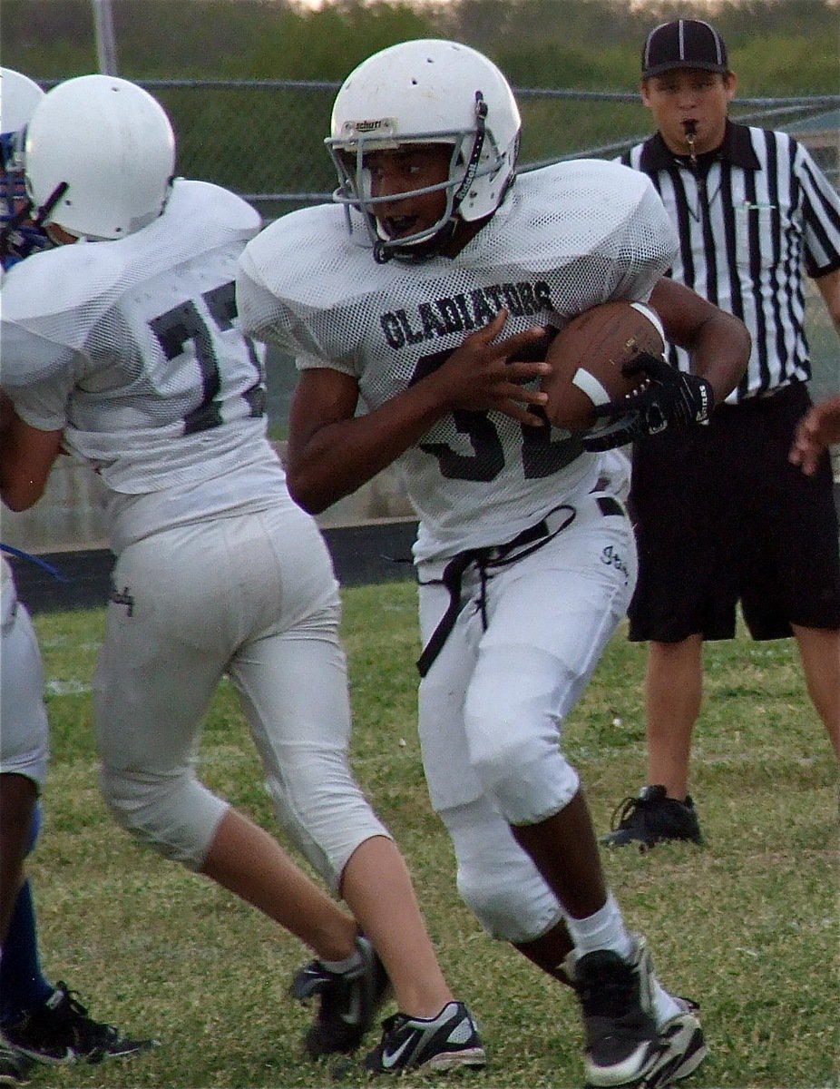 Image: Center Brandon Connor(77) buys time for Jaray Anderson(32).