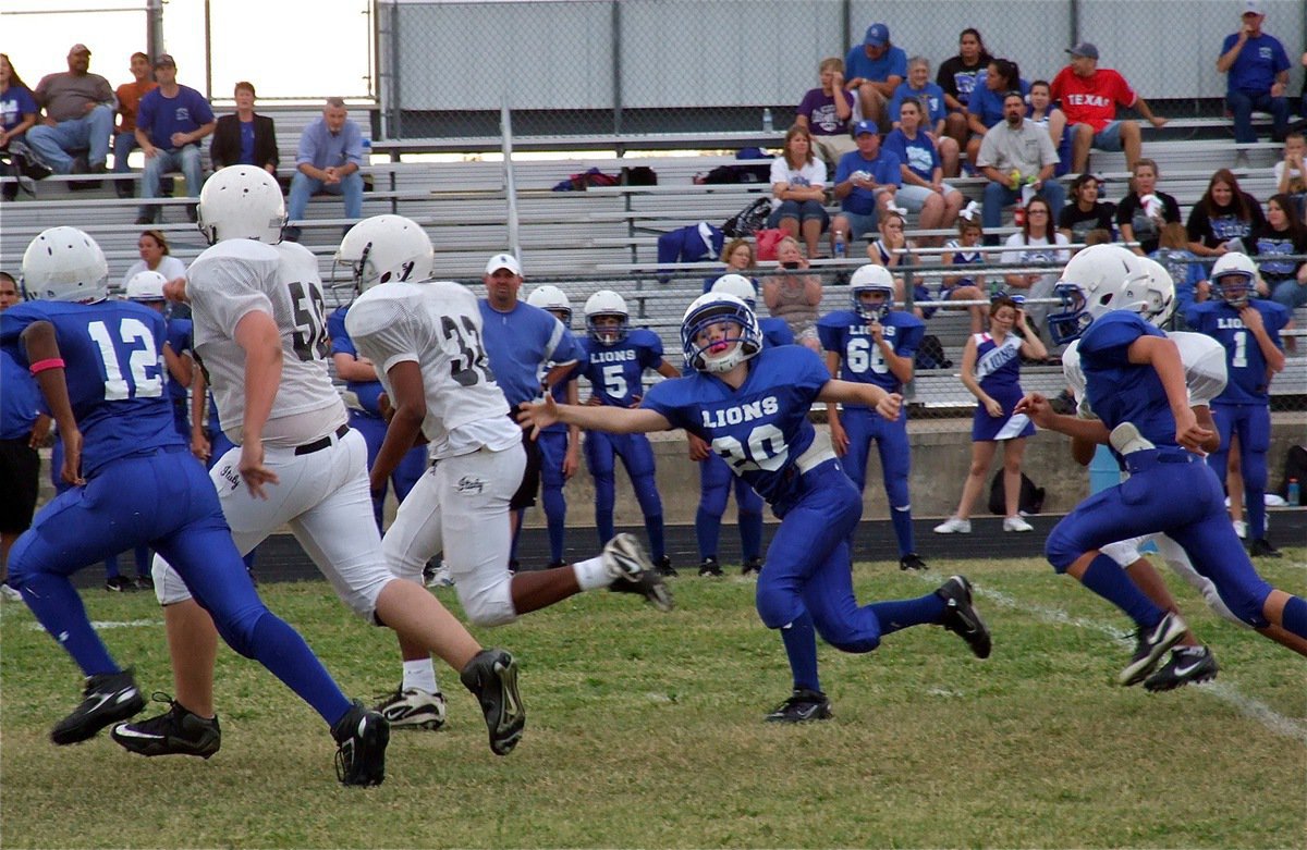 Image: Aaron Pittmon(50) leads Jaray Anderson(32) down the field.