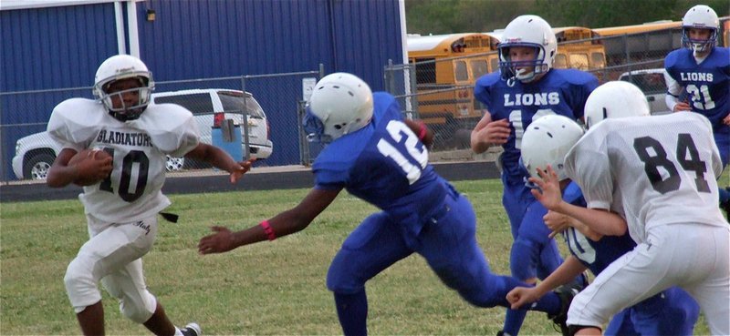 Image: Cameron Carter(10) tries to make use of a block executed by Ty Windham(84).