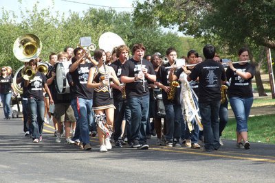 Image: The Gladiator Regiment Marching Band leads the homecoming parade into downtown Italy.