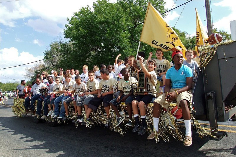 Image: Here come the IYAA football players (K-6th grades) and volunteer coaches.