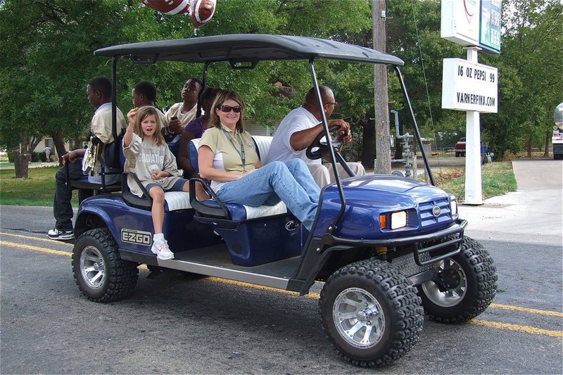 Image: Larry Mayberry, Sr. escorts Tanya Snook and her daughter Hailey, along with, IYAA football players Chasston Wilson, Kevin Johnson and Cameron Carter.