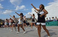 Image: Proceeding the homecoming parade, IHS Cheerleaders Bailey DeBorde, Felicia Little, Beverly Barnhart, Jameka Copeland, Madison Washington, Kaitlyn Rossa, Ashley Harper and Destani Anderson perform a cheer during the pep rally on the site of the recently removed community center.