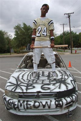 Image: Gladiator Eric Carson holds the sledge hammer that’s about to bash in the car that has Blooming Grove’s initials on it.