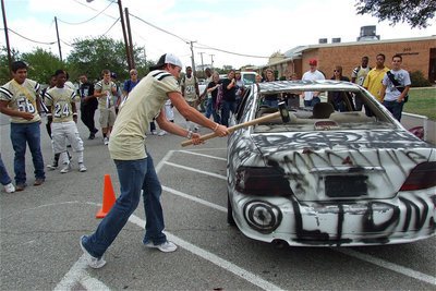 Image: Gladiator quarterback Jase Holden(3) delivers a shot to the poor car representing the Blooming Grove Lions.