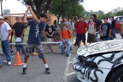Image: Mason Womack gives it a go during the Car Bash held at the IHS campus on Friday.