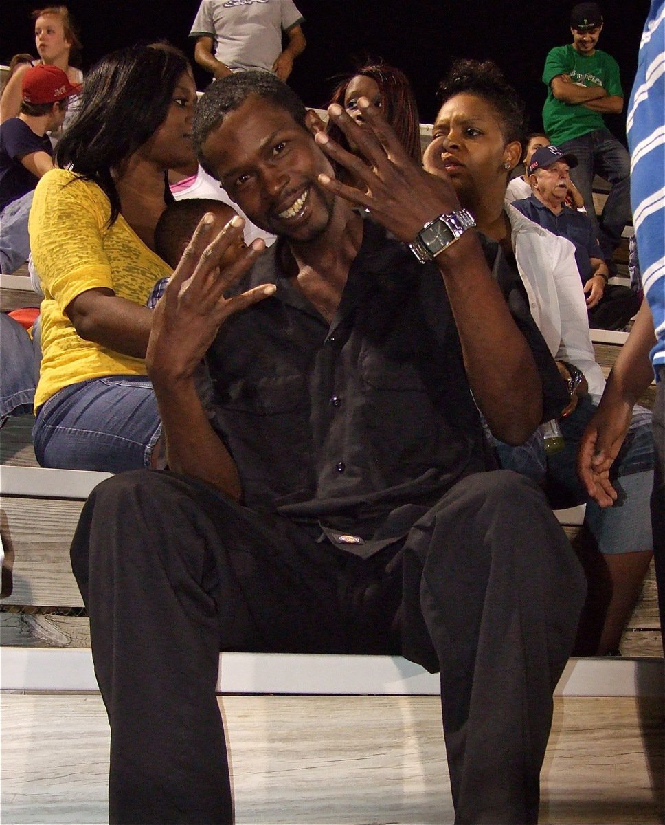 Image: Proud father and Gladiator Football alumni Byron Lusk (’89) holds up nine fingers to honor his son Devonta Simmons who wears #9 for the Gladiators.