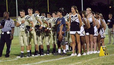 Image: The Gladiators and the IHS Cheerleaders stand for the National Anthem.