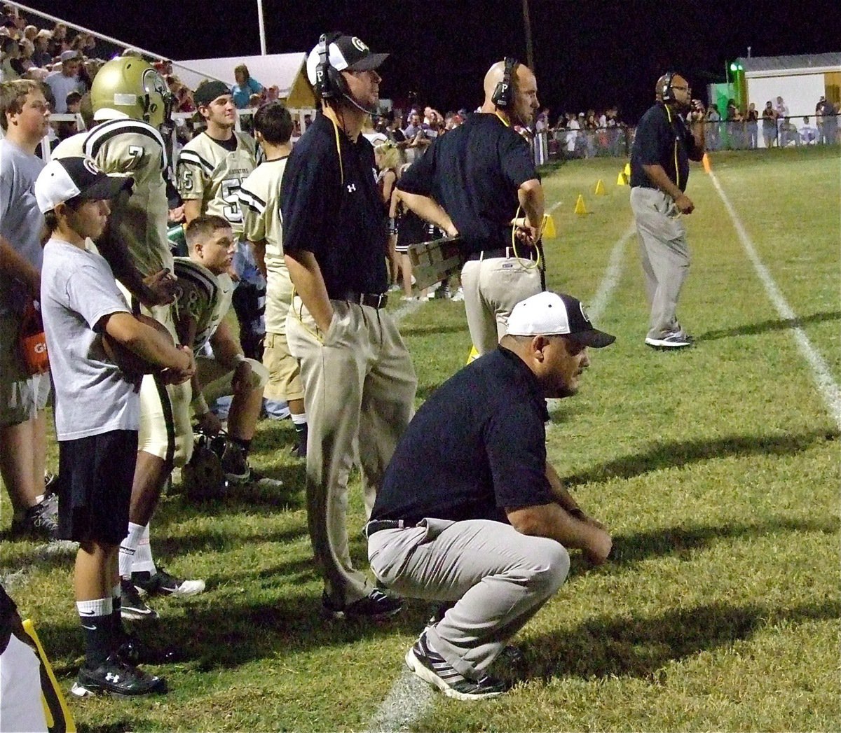 Image: Gladiator head coach Craig Bales takes a grass blade view of the battle between his troops and the Lions.