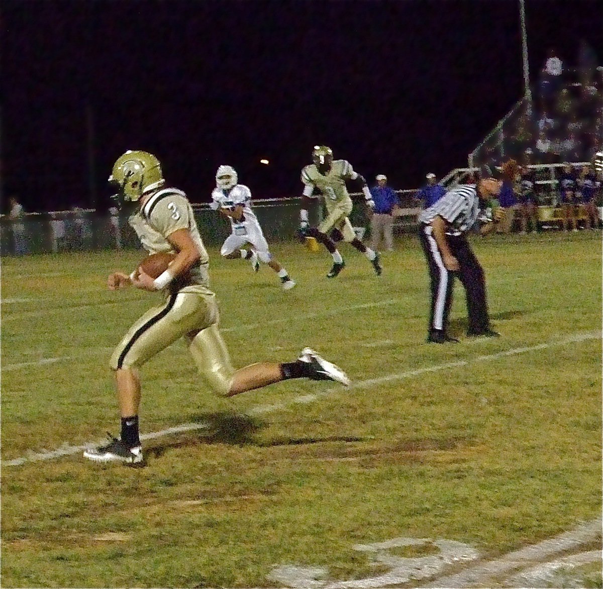 Image: Quarterback Jase Holde slips thru the Lion defense for a 71-yard touchdown run.