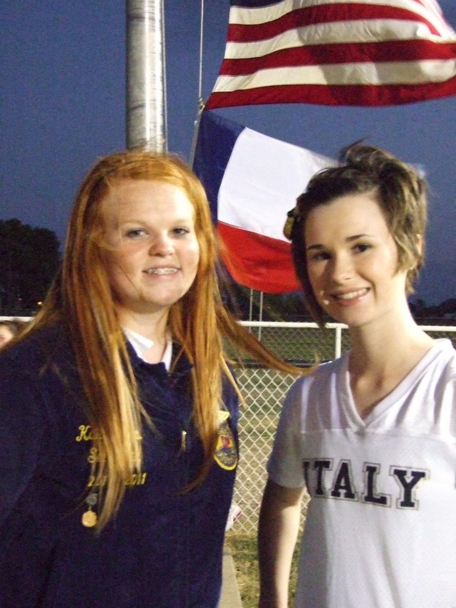 Image: Katie Byers and Meagan Hooker handle the honor of raising the flags.