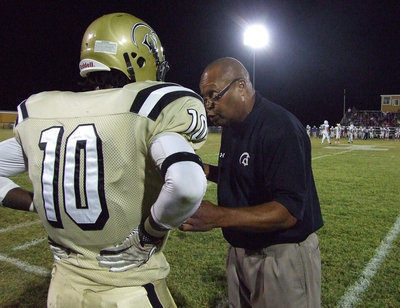 Image: Coach Larry Mayberry, Sr. gives Ryheem Walker(10) a quick lesson.