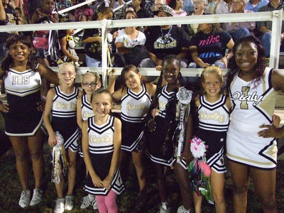 Image: Third and Fourth grade IYAA cheerleaders cheer with the varsity cheerleaders at Homecoming.