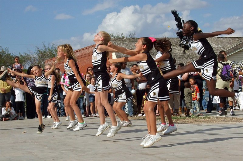 Image: IYAA B-Team cheerleaders jump and yell after performing a cheer for the community during the IHS Homecoming Pep Rally held in downtown Italy on Friday.