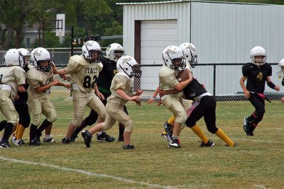 Image: Preston Rasco(9), Michael Gonzalez(30), Brennon Sigler(82) and Ty Cash(24) try to make running room for Gage Wafer(29) against the Jaguars during the B-Team game.