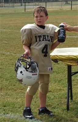 Image: Bryce DeBorde receives a squirt bottle and football after the IYAA B-Team’s homecoming win over the Hubbard Jaguars, 30-26.